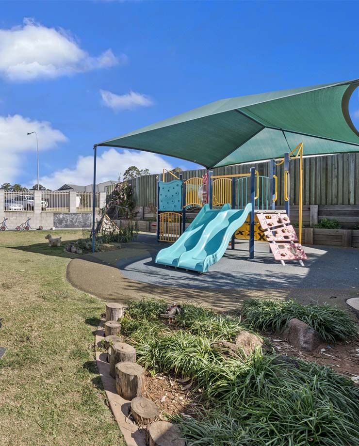 Kate's Place exterior play equipment and grassed area